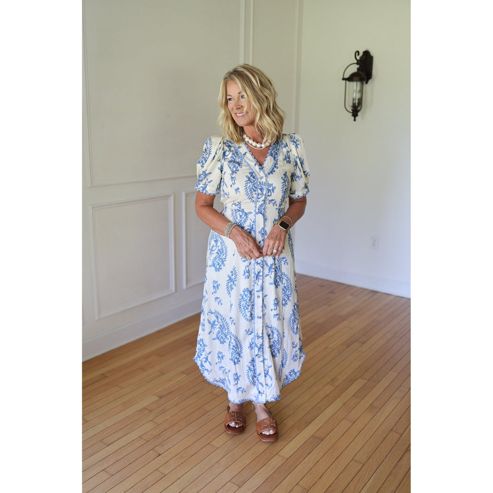 Woman wearing a blue and white floral dress 