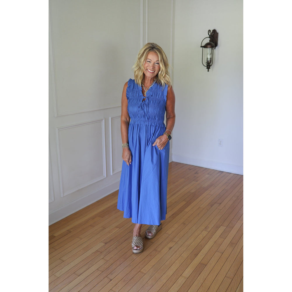 Woman in a blue dress standing 