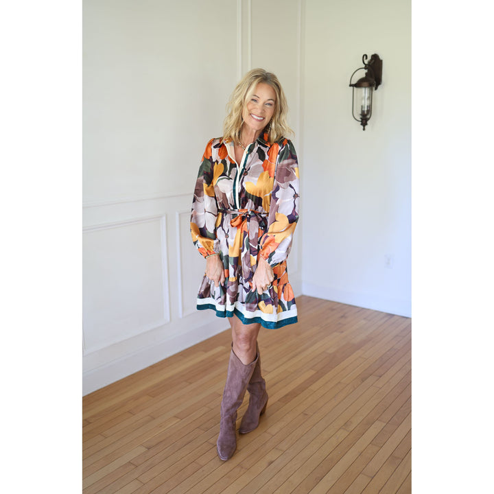Woman wearing a colorful dress and brown boots 