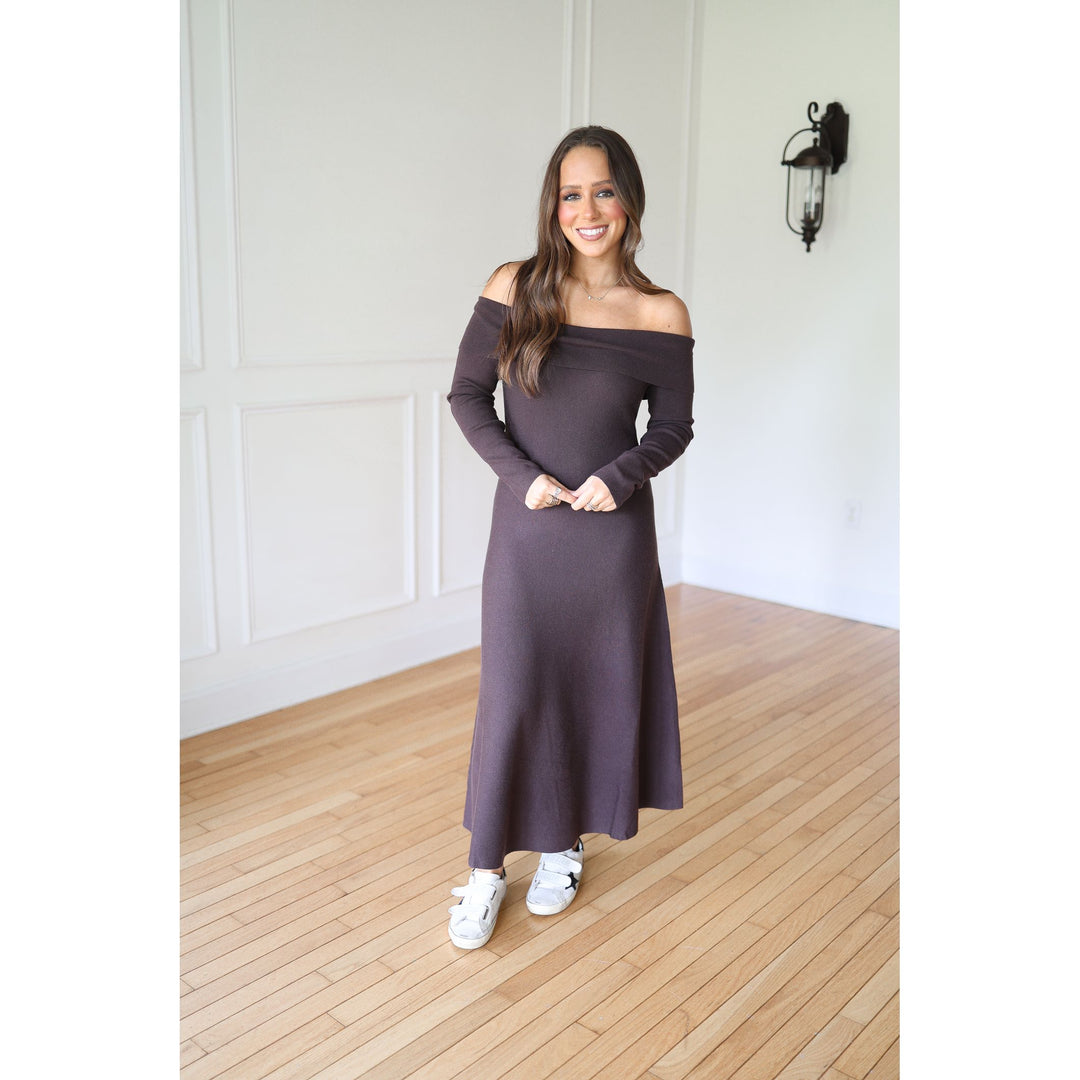 Woman wearing a long, brown off-shoulder dress 