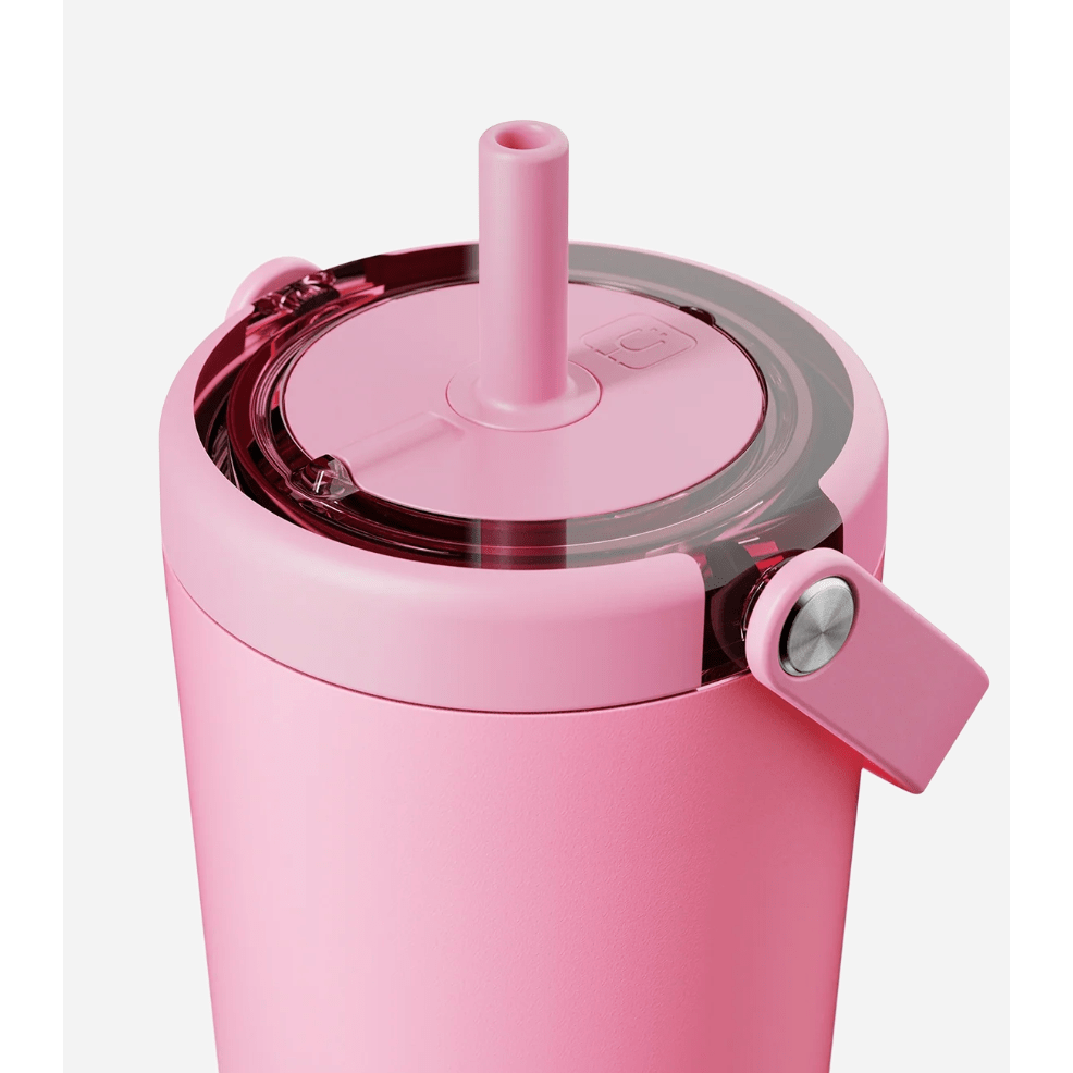 Pink tumbler with straw and lid on a white background