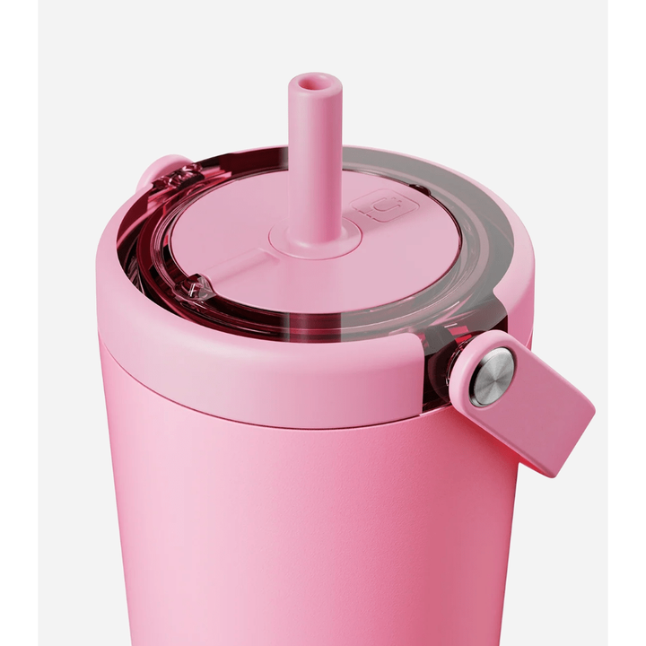Pink tumbler with straw and lid on a white background