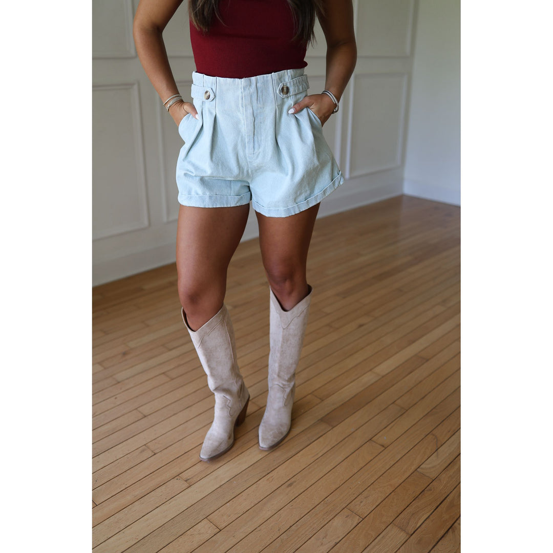 Person wearing light blue shorts and white boots 