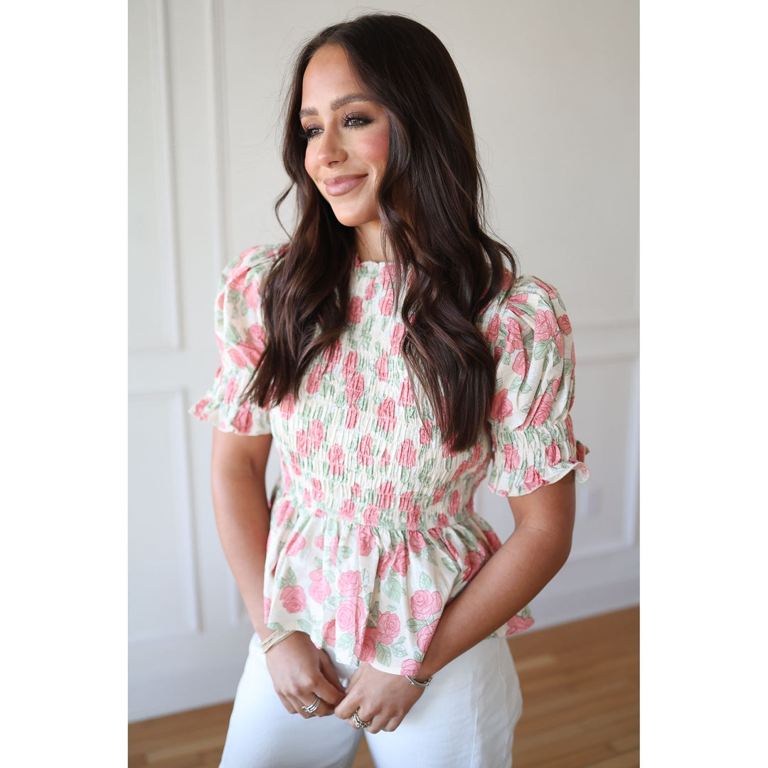 Woman wearing a floral blouse with a white background