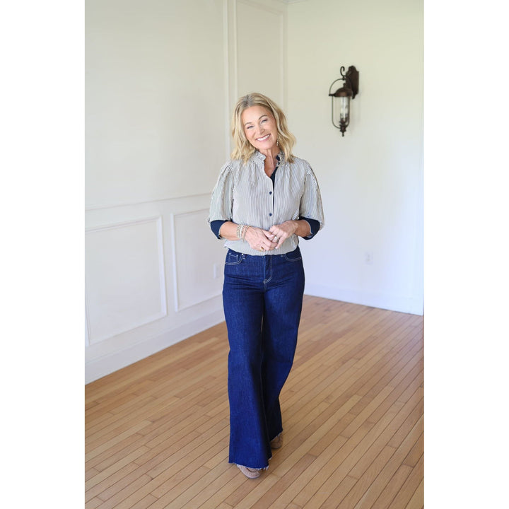 Woman wearing a striped blouse and blue jeans 