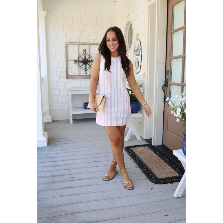 Woman in a striped dress standing on a porch