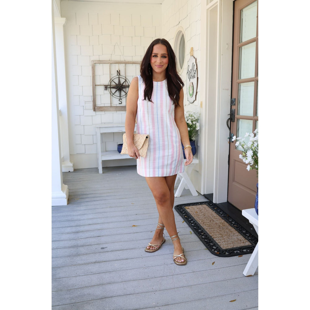 Woman in a striped dress standing on a porch