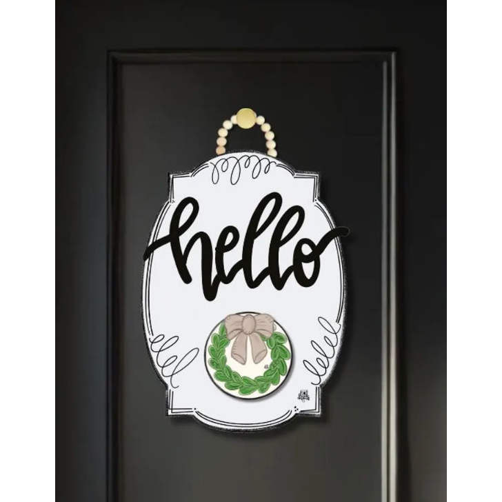 Decorative door sign with 'hello' text and wreath design on a black background