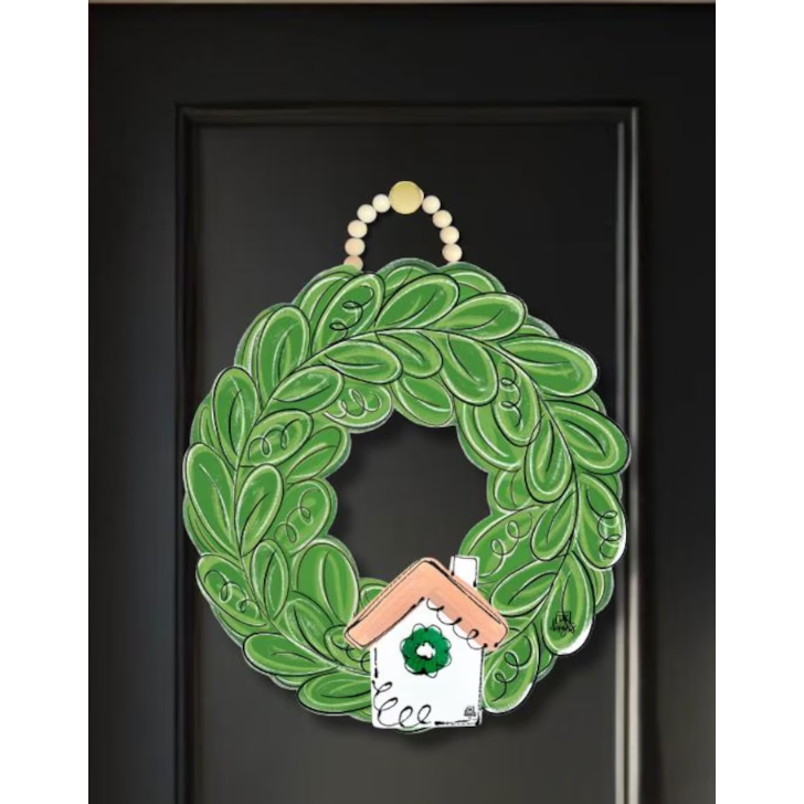 Green wreath with a small house design on a black background