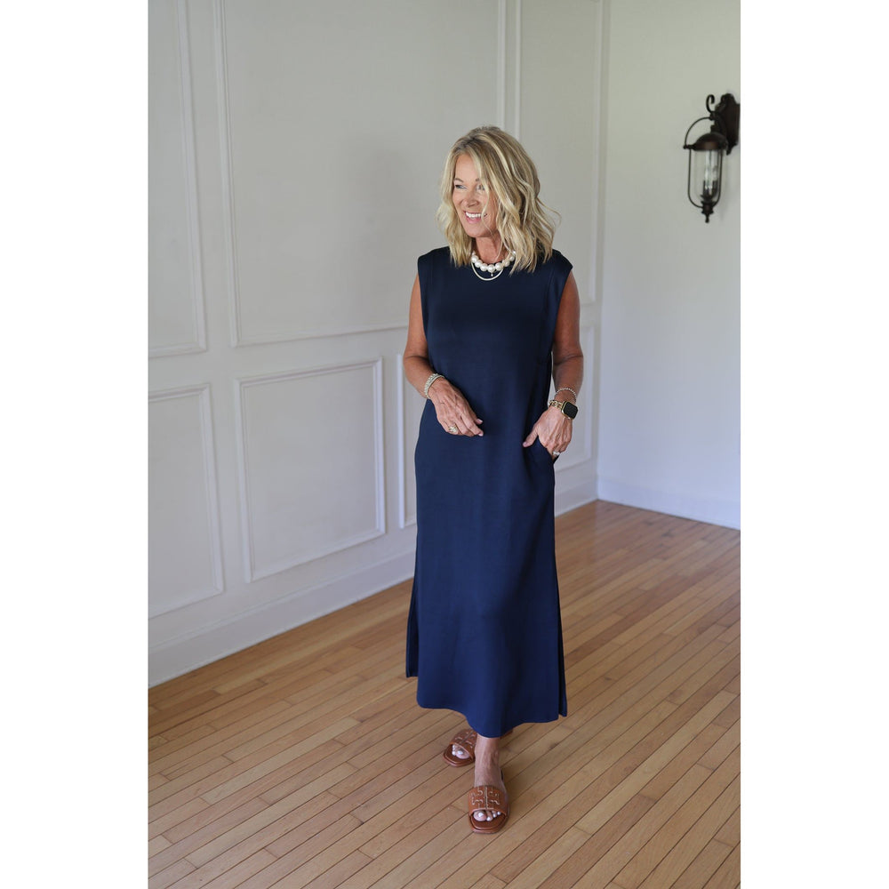 Woman wearing a navy sleeveless dress 