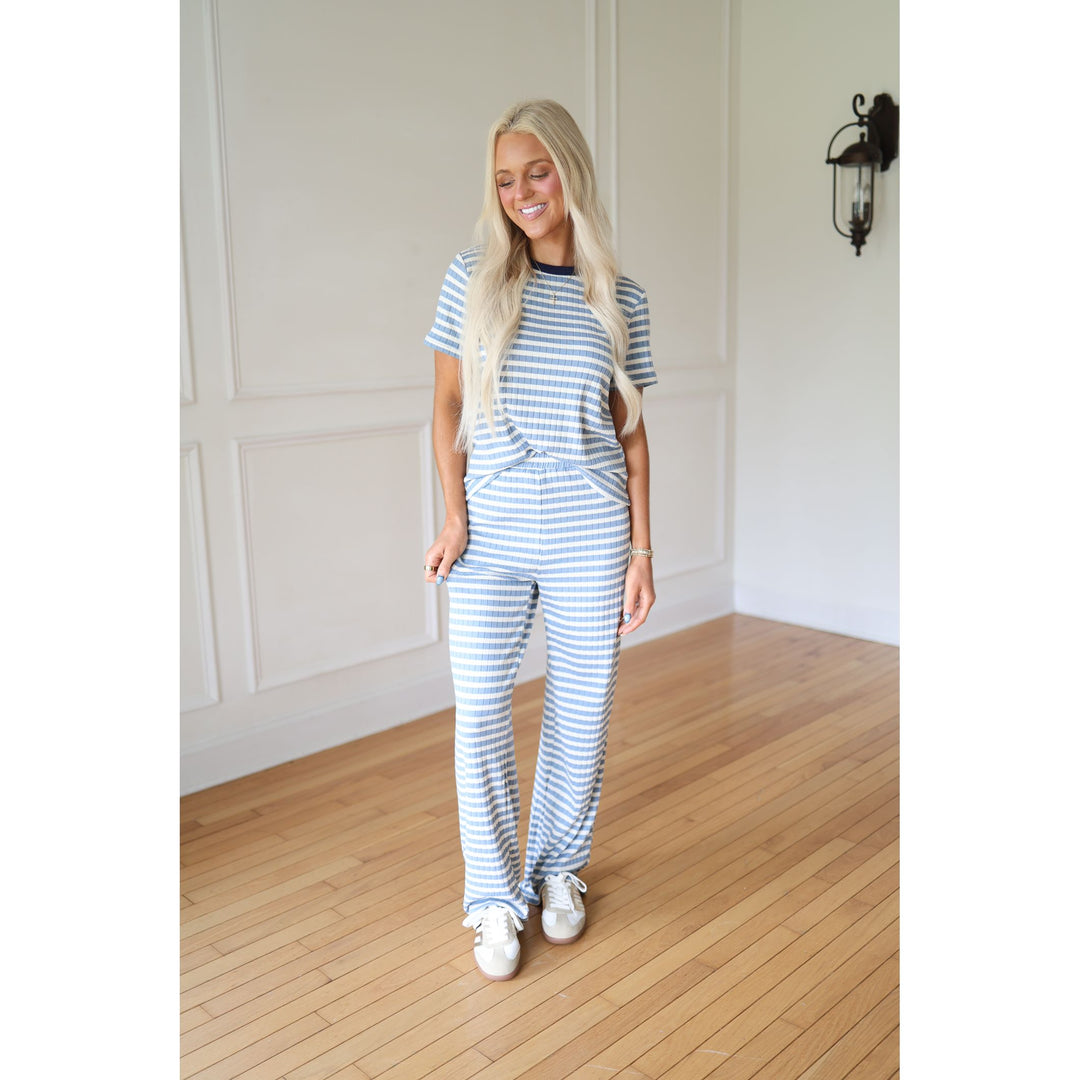Woman wearing a blue and white striped outfit 