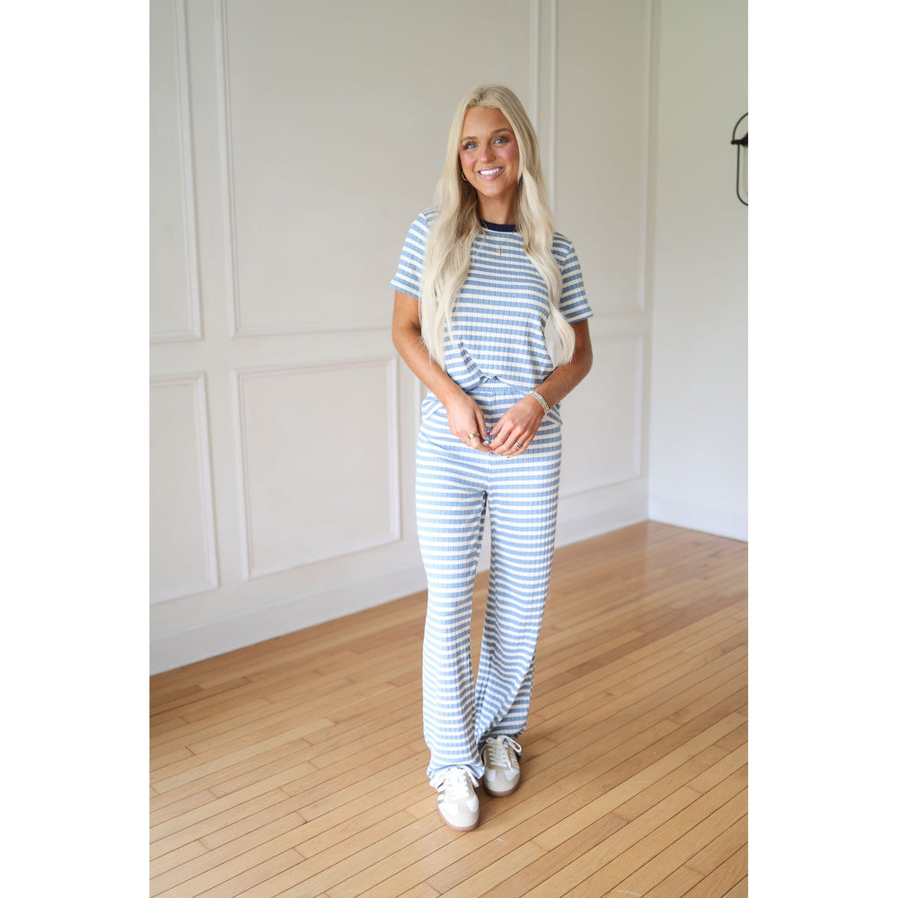 Woman wearing a blue and white striped outfit 
