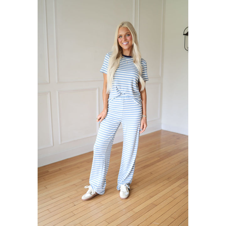 Woman wearing a blue and white striped outfit