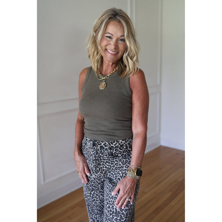 Woman wearing a green sleeveless top a
