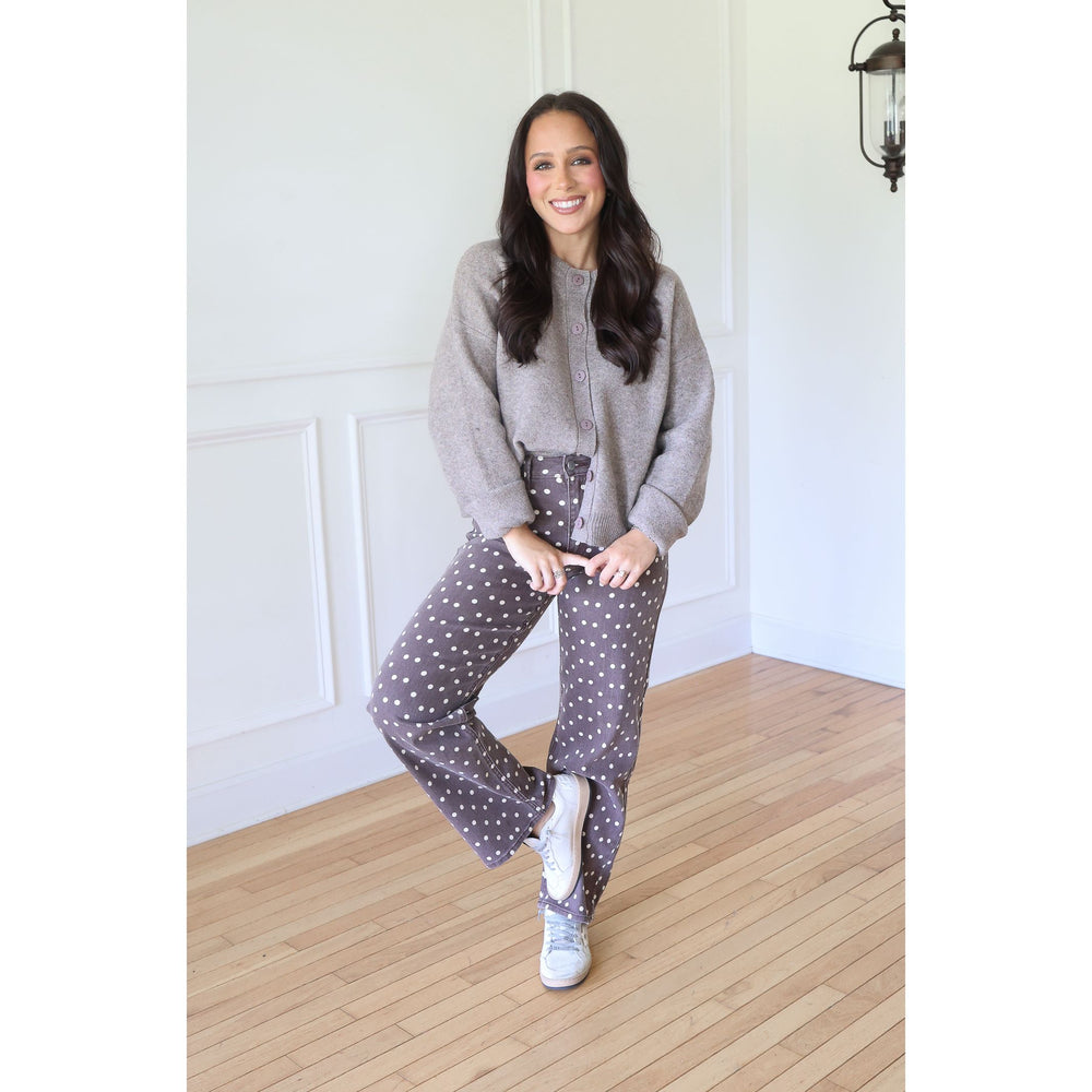 woman wearing a mocha cardigan and brown polka dotted pants and sneakers