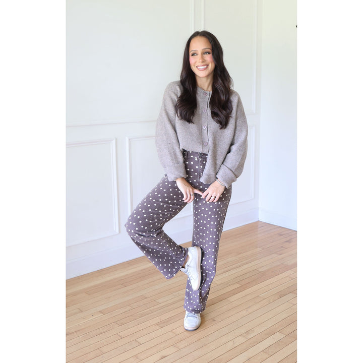 woman wearing mocha cardigan with brown pants with white polka dots and sneakers