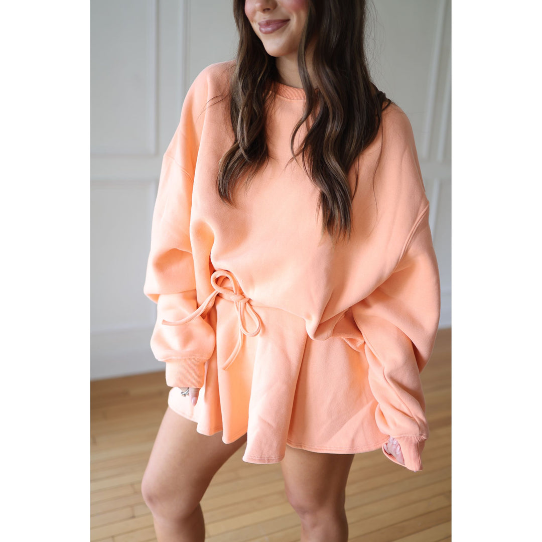 Woman wearing a coral-colored outfit 