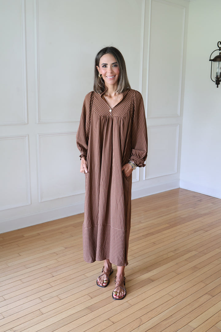 woman wearing brown striped maxi dress