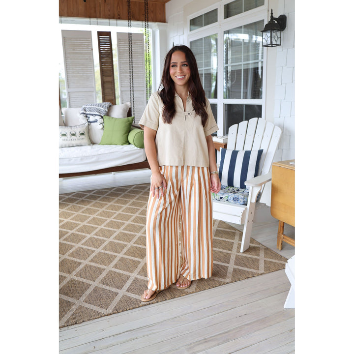 woman wearing brown pants and tan top