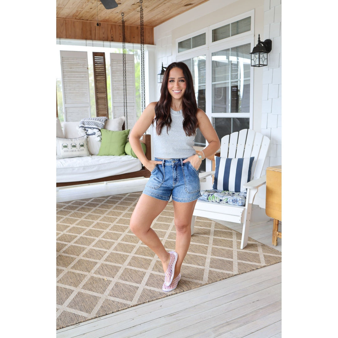 woman wearing denim shorts and a gray tank