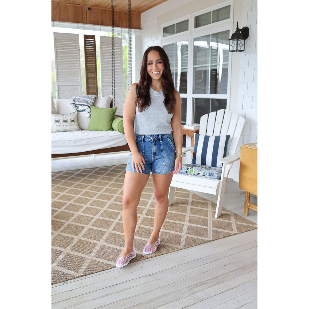 woman wearing denim shorts and a gray tank