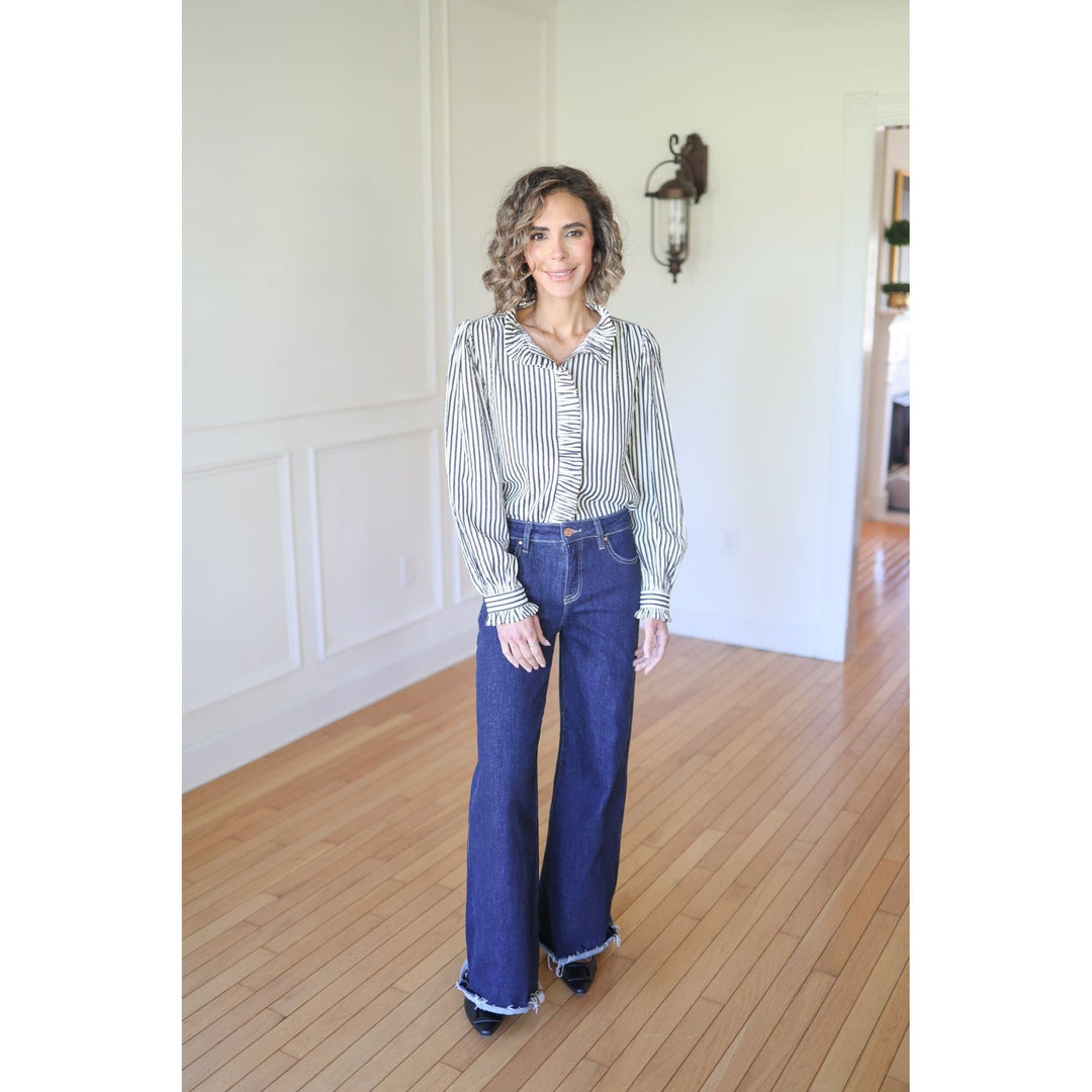Woman wearing a striped shirt and blue jeans 