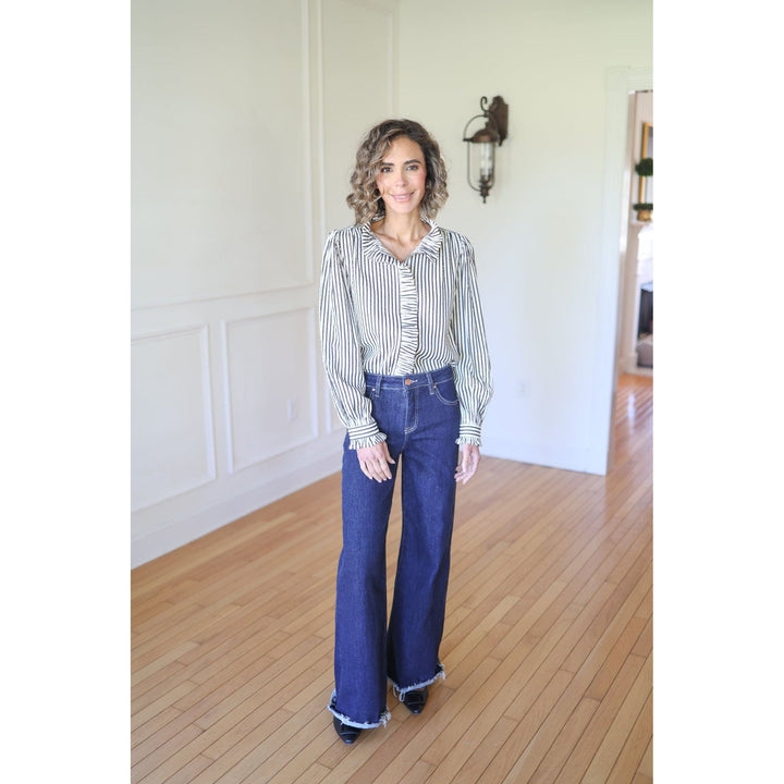 Woman wearing a striped shirt and blue jeans 