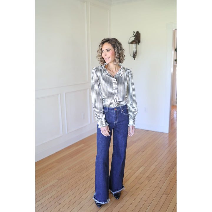 Woman wearing a striped shirt and blue jeans 