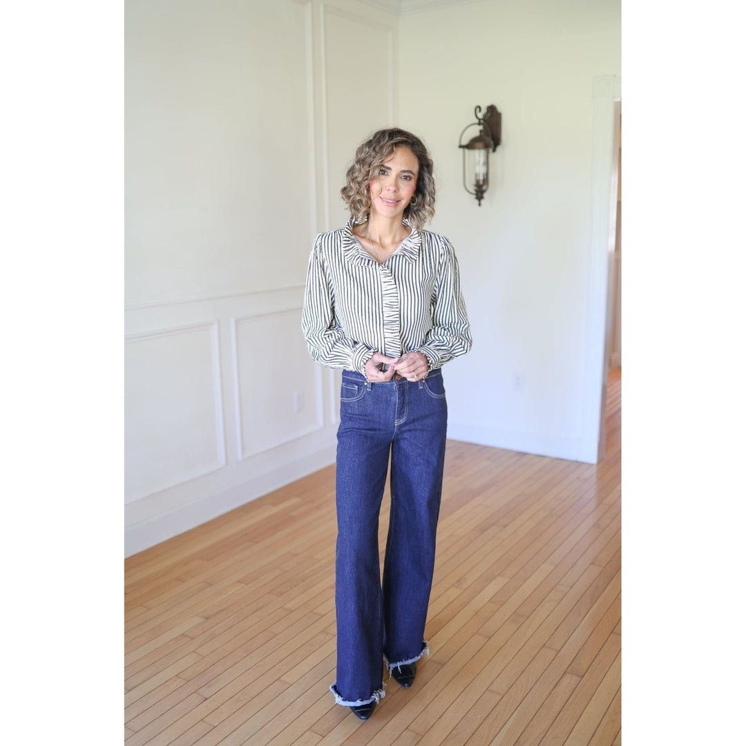 Woman wearing a striped shirt and blue jeans s