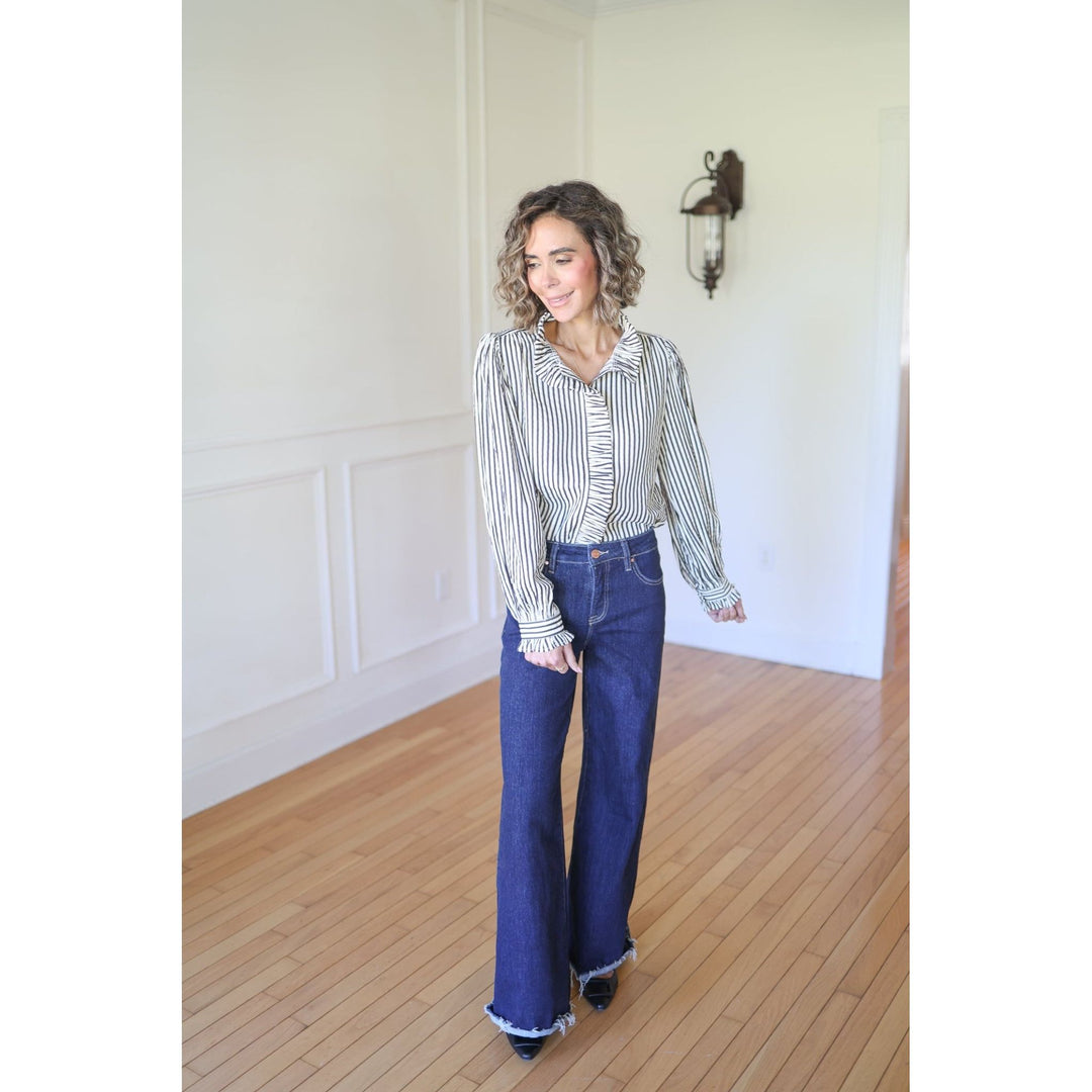 Woman wearing a striped shirt and blue jeans 
