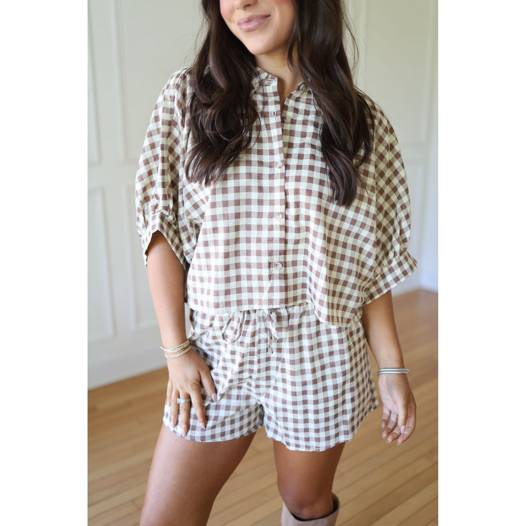 Woman wearing a brown and white checkered outfit 