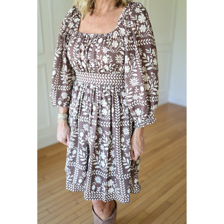 Woman wearing a brown floral dress 