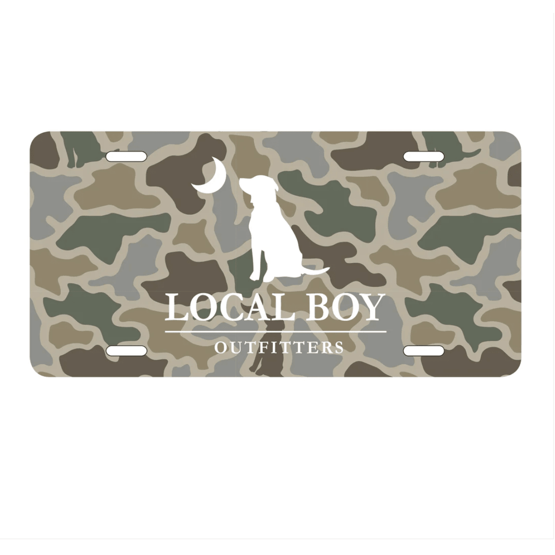 Camouflage license plate with 'Local Boy Outfitters' branding and a dog silhouette.