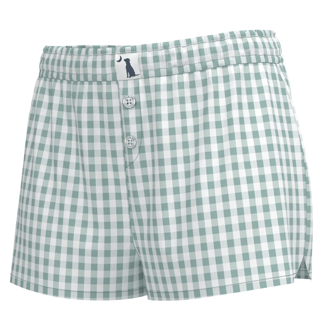Green and white checkered shorts with a button closure on a white background