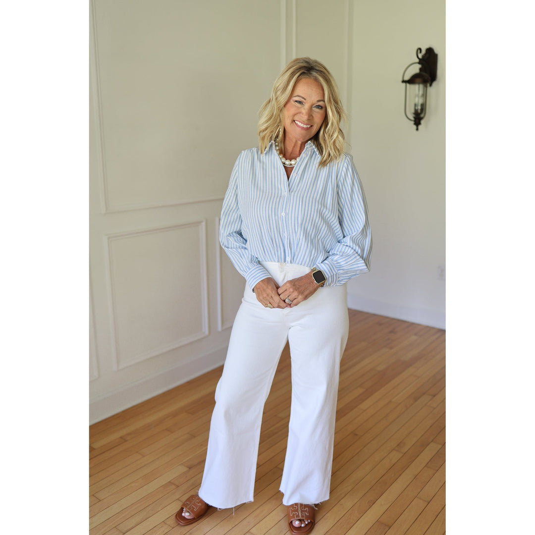Woman wearing a blue and white striped shirt 