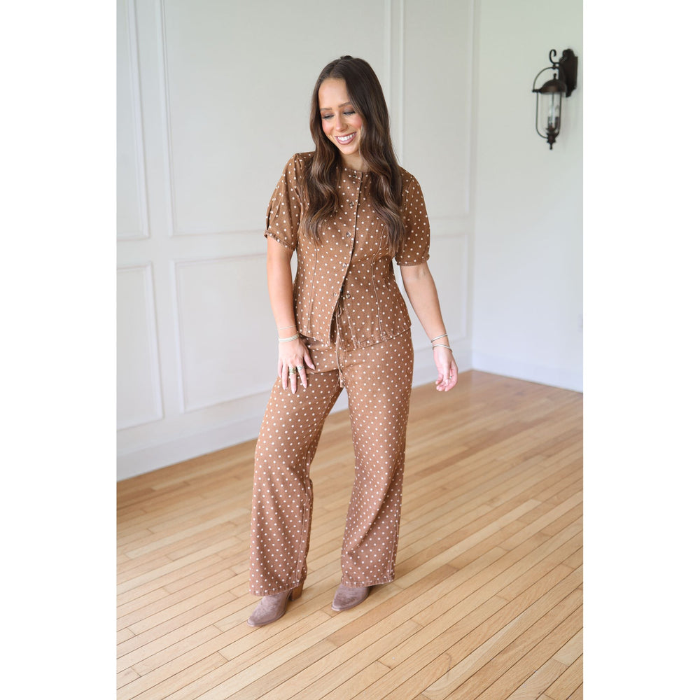 Woman wearing a brown polka dot outfit 
