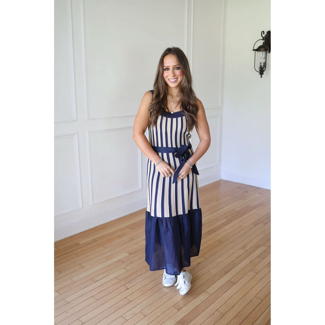 Woman wearing a blue and white striped dress 