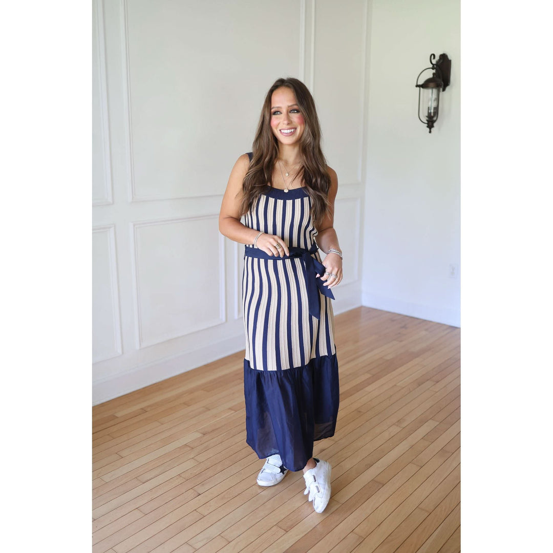 Woman wearing a blue and white striped dress 