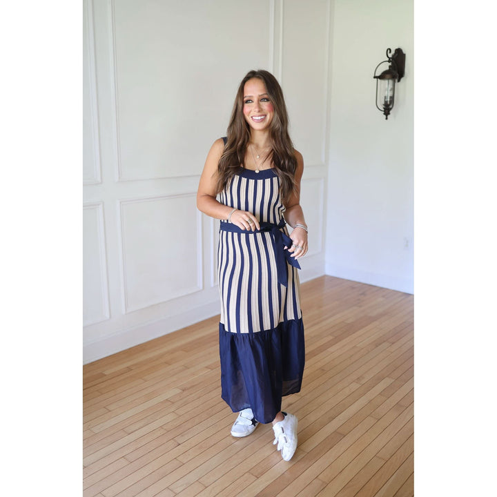 Woman wearing a blue and white striped dress 