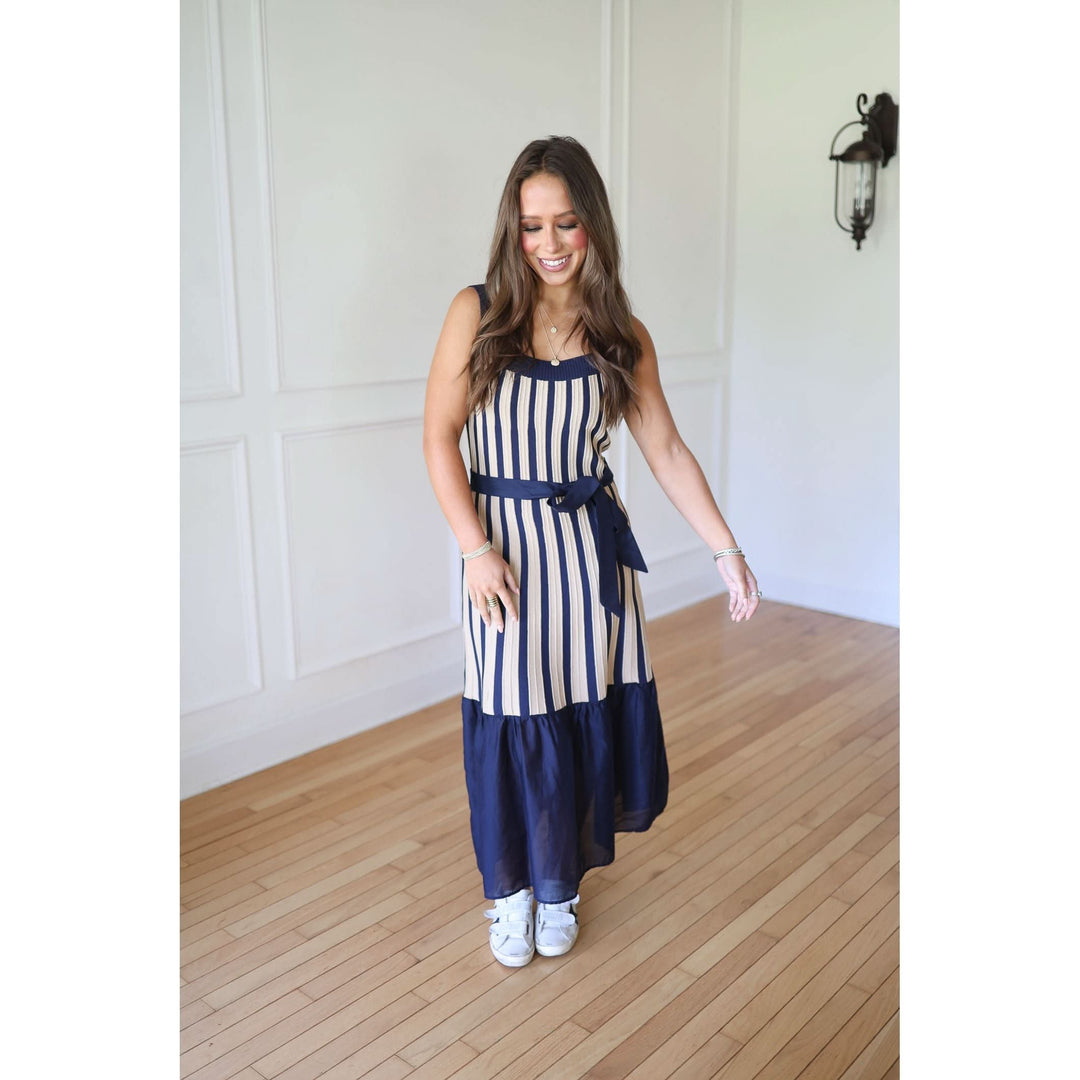 Woman wearing a navy and white striped dress 
