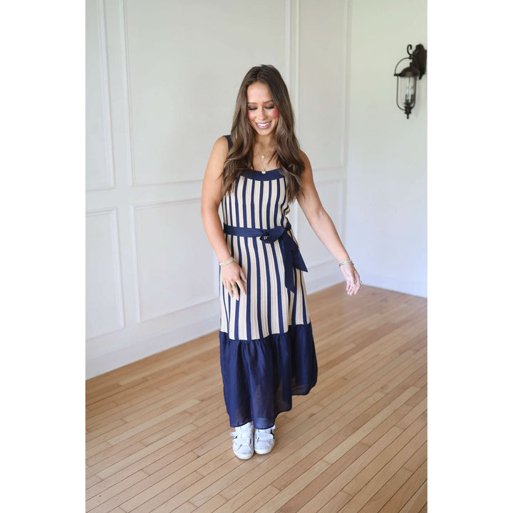 Woman wearing a navy and white striped dress 