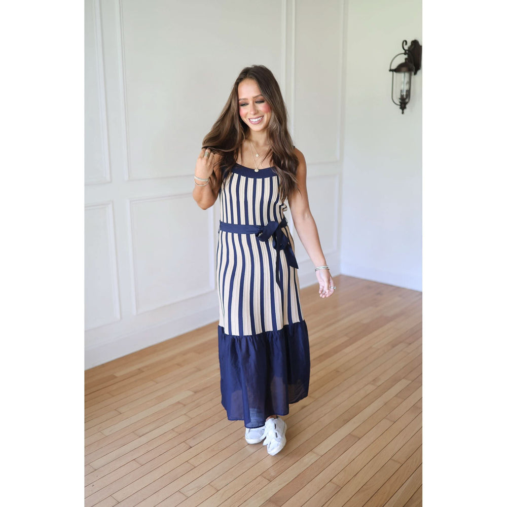 Woman wearing a blue and white striped dress 