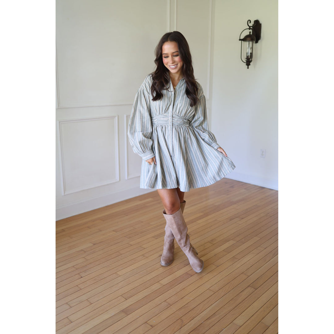 Woman in a striped dress and knee-high boots 