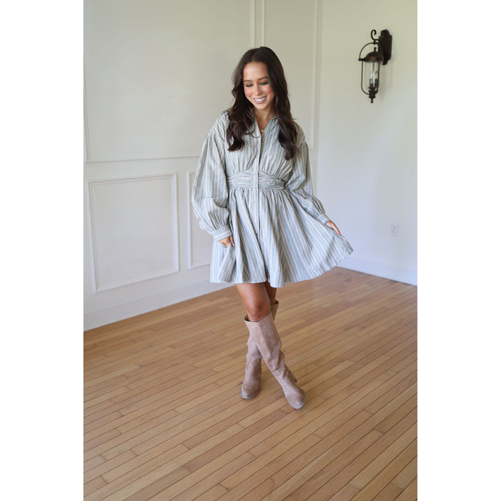 Woman in a striped dress and knee-high boots 