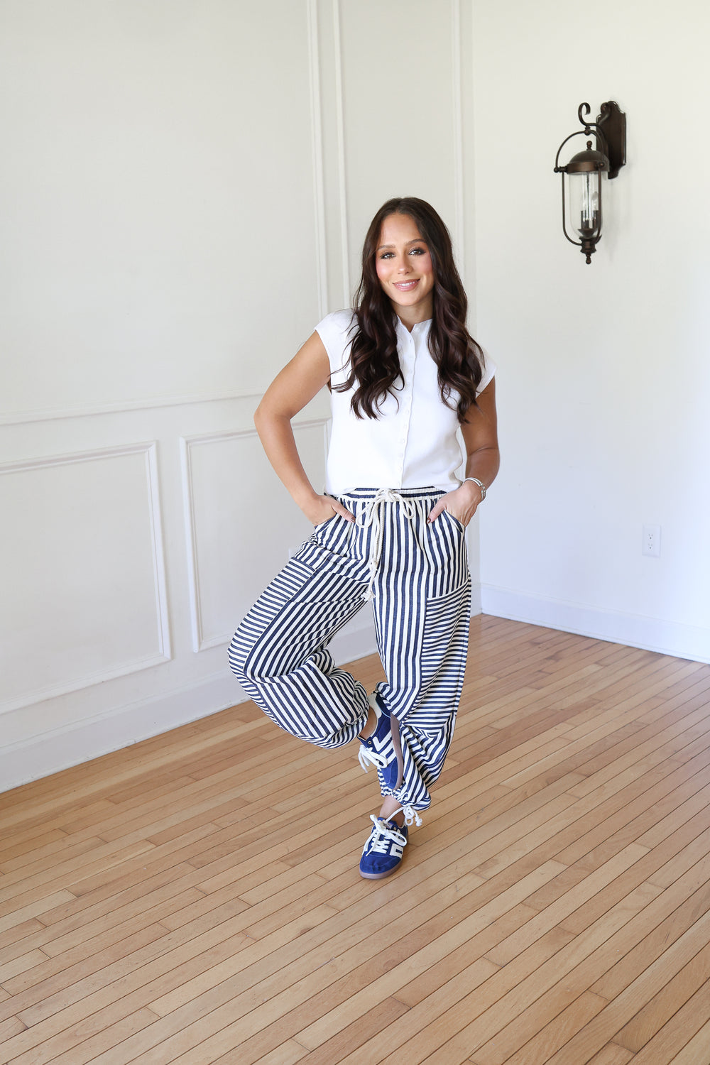 woman wearing Ivory Cap Sleeve Mock Neck Cardigan and striped pants