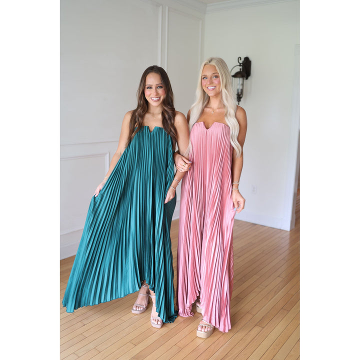 Two women wearing long, flowing dresses 