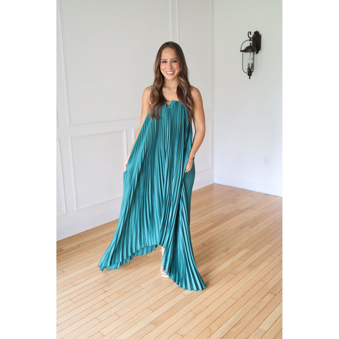 Woman wearing a teal pleated dress 