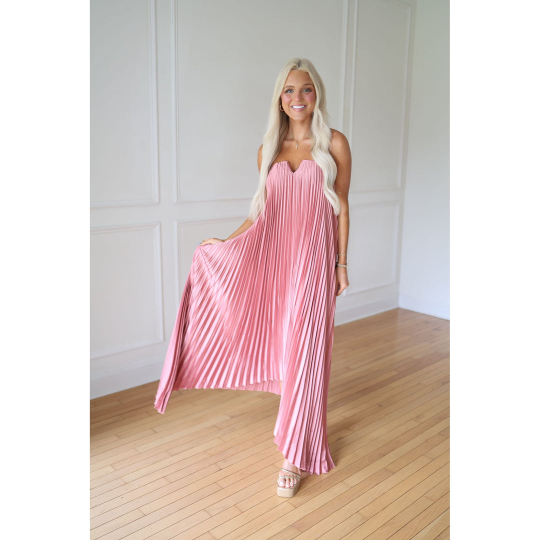Woman wearing a pink pleated dress 