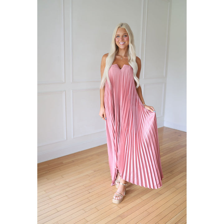 Woman wearing a pink pleated dress