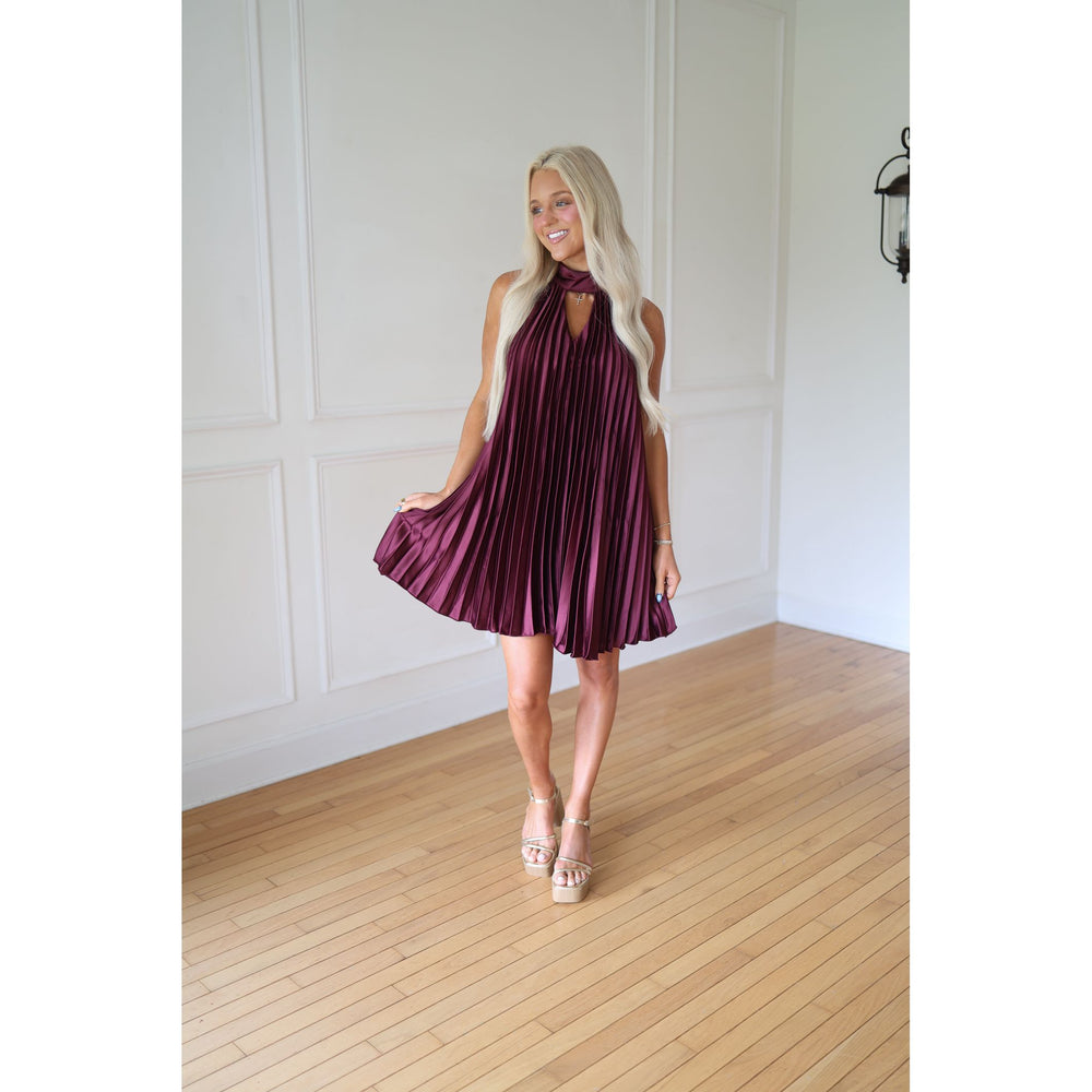 Woman wearing a wine pleated dress
